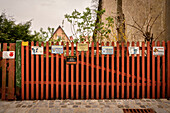 Garden fence in the historic old town of Dinkelsbühl on the Wörnitz (river) with numerous warning signs, Romantic Road, Ansbach district, Middle Franconia, Bavaria, Germany