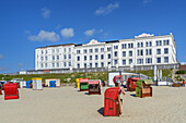 Beach chairs on the beach behind houses on the beach promenade, Borkum Island, Lower Saxony, Germany