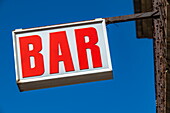 Red sign on a bar, Capestang, Hérault, France