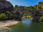 Aerial view from the rock arch Pont Arch in the Gorges de L'ardeche with canoes and sandbank of the Ardeche river, Labastide-de-Virac, Ardèche, Auvergne-Rhône-Alpes, France, Europe