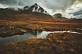 Mountains of Glen Coe with grass, bog and water, landscape in autumn, Highlands, Scotland, United Kingdom
