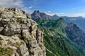 Woman hiking on the ridge path, Feltriner Berge, Belluneser Höhenweg, Dolomites, Veneto, Venetia, Italy