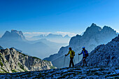 Man and woman hiking with Monte Pelmo and Cima di Pramper in the background, Belluneser Höhenweg, Dolomites, Veneto, Venetia, Italy