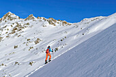 Woman on ski tour ascending to Marchkopf, Marchkopf, Hochfügen, Zillertal, Tux Alps, Tyrol, Austria