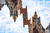 Double exposure of a stepped gable house and the Jerusalem church in Bruges, Belgium.