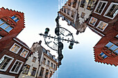 Double exposure of a ornate streetlamp and stepped gables houses in Bruges, Belgium.