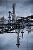 Double exposure of the chimneys and tubes of a chemical plant.