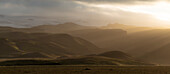 Low midnight sun over rolling hills in southern Iceland