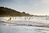 numerous surfers at the surf spot at Playa Zicatela, Puerto Escondido, Oaxaca, Mexico, North America, Latin America, Pacific Ocean