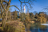 Frozen pond in the castle park of Bad Homburg in front of the height with white tower, Taunus, Hesse, Germany