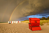 Beach chairs with a rainbow after the storm, Mecklenburg-Western Pomerania, North Germany, Germany