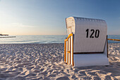 White beach chair in the evening light on the beach of Zingst, Mecklenburg-Western Pomerania, Baltic Sea, Northern Germany, Germany