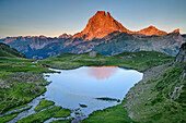 Alpenglow at Pic du Midi with mountain lake in foreground, Vallee d&#39; Ossau, Pyrenees National Park, Pyrenees, France