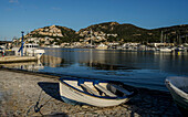 Fishing boats in the harbor and a view of Port d'Andratx reflected in the water, Mallorca, Spain