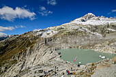 Several people hike to the source of the Rhone, Uri Alps, Valais, Switzerland