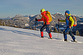 Man and woman hiking with snowshoes on the Gaisberg, Salzkammergut Mountains in the background, Gaisberg, Salzkammergut, Salzkammergut Mountains, Salzburg, Austria