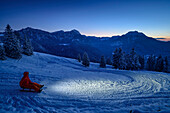 People drive in headlamp light with sleds from Farrenpoint, Farrenpoint, Bavarian Alps, Upper Bavaria, Bavaria, Germany