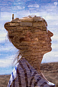 Double exposure portrait of a woman and a sandstone wall..