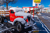 Snow covered oldtimer truck parked in front of Aikens lodge in Kanab, Utah.