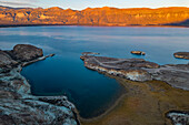 Aerial view showing the distinctive and remote Arco de Piedra in front of a bay at sunrise near the Chilean border, Lago Posadas, Argentina, Patagonia