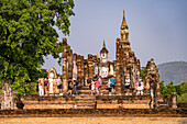 Tourists at the central Buddhist temple Wat Mahathat, UNESCO World Heritage Sukhothai Historical Park, Thailand, Asia