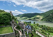 View over the tournament grounds, the outer bailey and the castle hotel, in the background the Königstein watchtower and the Rhine Valley near Trechtingshausen, Upper Middle Rhine Valley, Rhineland-Palatinate, Germany