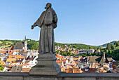 View from the Cloak Bridge with a sculpture of St. Felix of Cantalicia on the Old Town of Český Krumlov with St. Vitus Church in South Bohemia in Czech Republic