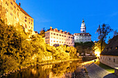 Castle and small castle with castle tower over the Vltava river in the evening light in Český Krumlov in South Bohemia in the Czech Republic