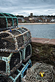 View of North Berwick with lobster pots in the foreground, East Lothian, Scotland, United Kingdom