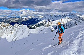 Woman on ski tour looks into Grinbergkar, Grinbergspitze, Tuxer Kamm, Zillertal Alps, Tyrol, Austria