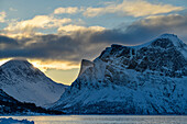 Sunrise over the mountains at Nordfjord, Nordfjord, Skaland, Senja, Troms og Finnmark, Norway