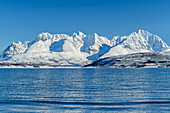 Snowy Lyngen Alps from Oldervik beach, Oldervik, Troms og Finnmark, Norway
