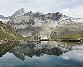 Mountains and chapel are reflected in Schwarzsee, Zermatt, Switzerland