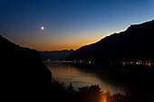 View over Lake Brienz with Mountain and Moon in Twilight in Bern Canton, Switzerland.