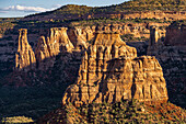 Dusk light illuminates the monumnets in Monument Canyon in Colorado National Monument