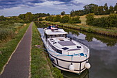 Aerial view of friends having dinner on deck of a Le Boat Horizon 5 houseboat moored on the Canal de la Marne au Rhin, Gondrexange, Moselle, France