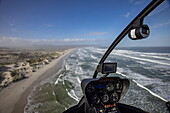 Aerial view through the windscreen of a helicopter over the coast and beach at Walker Bay Nature Reserve, Gansbaai De Kelders, Western Cape, South Africa