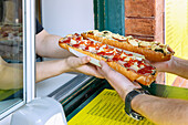 Zapiekanki, baked baguette, at Hala Targowa on the Plac Novy market square in Kraków in Poland