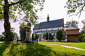 Gothic parish church of St. Peter and Paul (Kościół pw. śś. Piotra i Pawła) and free-standing wooden bell tower in Beszowa in Świętokrzyskie Voivodeship of Poland