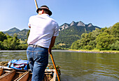 Rafting trip in the Dunajec Canyon in the Pieniny National Park (Pieninský Park Narodowy) with a view of the Three Crowns (Trzy Korony) in southern Poland in the Malopolskie Voivodeship in Poland