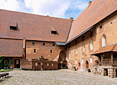 Inner courtyard of the central castle of the Marienburg (Zamek w Malborku) with a monumental figure of the Virgin Mary in Malbork in the Pomorskie Voivodeship in Poland