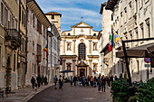 Via Rodolfo Belenzani in the old town and the church Chiesa di San Francesco Saverio in Trento, Trentino, Italy, Europe