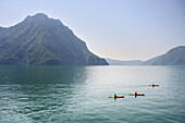 Kayak rider in Lake Iseo (Lago d'Iseo, also Sebino) near Castro, Brescia and Bergamo, Northern Italian Lakes, Lombardy, Italy, Europe