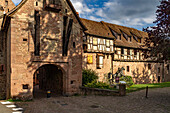 The upper gate La Porte Haute and half-timbered houses of the city walls of Riquewihr, Alsace, France