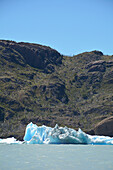 Chile; Southern Chile; Magallanes region; Mountains of the southern Cordillera Patagonica; Torres del Paine National Park; Lake Grey; in the foreground iceberg; rocky hilly landscape in the background