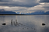 Chile; Southern Chile; Magallanes Region; Puerto Natales; historic pier at Seno de Ultima Esperanza; in the background the mountains of the southern Cordillera Patagonica