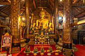 Buddha statue in the interior of the Buddhist temple Wat Xieng Thong in Luang Prabang, Laos, Asia