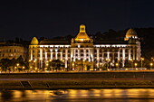 Illuminated Gellertbad building along the Danube at night, Budapest, Pest, Hungary, Europe