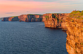Ireland, County Clare, Cliffs of Moher, sunset, view from south to north in the afterglow