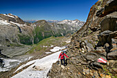 Woman hiking climbs up the Schönbichler Horn via an insured path, Schönbichler Horn, Zillertal Alps Nature Park, Zillertal Alps, Tyrol, Austria